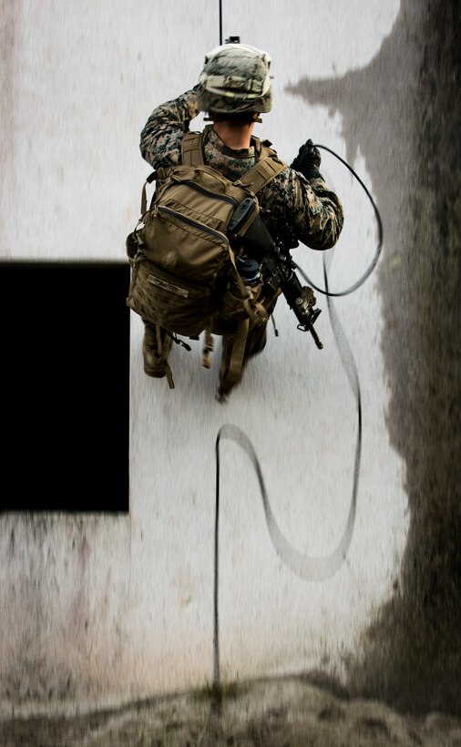 A U.S. Marine with Special-Purpose Marine Air-Ground Task Force Crisis Response-Africa rappels down a building during a training exercise with U.S. Army Special Forces in Baumholder, Germany, March 6, 2015. The ability to rappel down the side of structures allows service members to rapidly move in built-up urban environment. (U.S. Marine Corps photo by Sgt. Paul Peterson/Released)