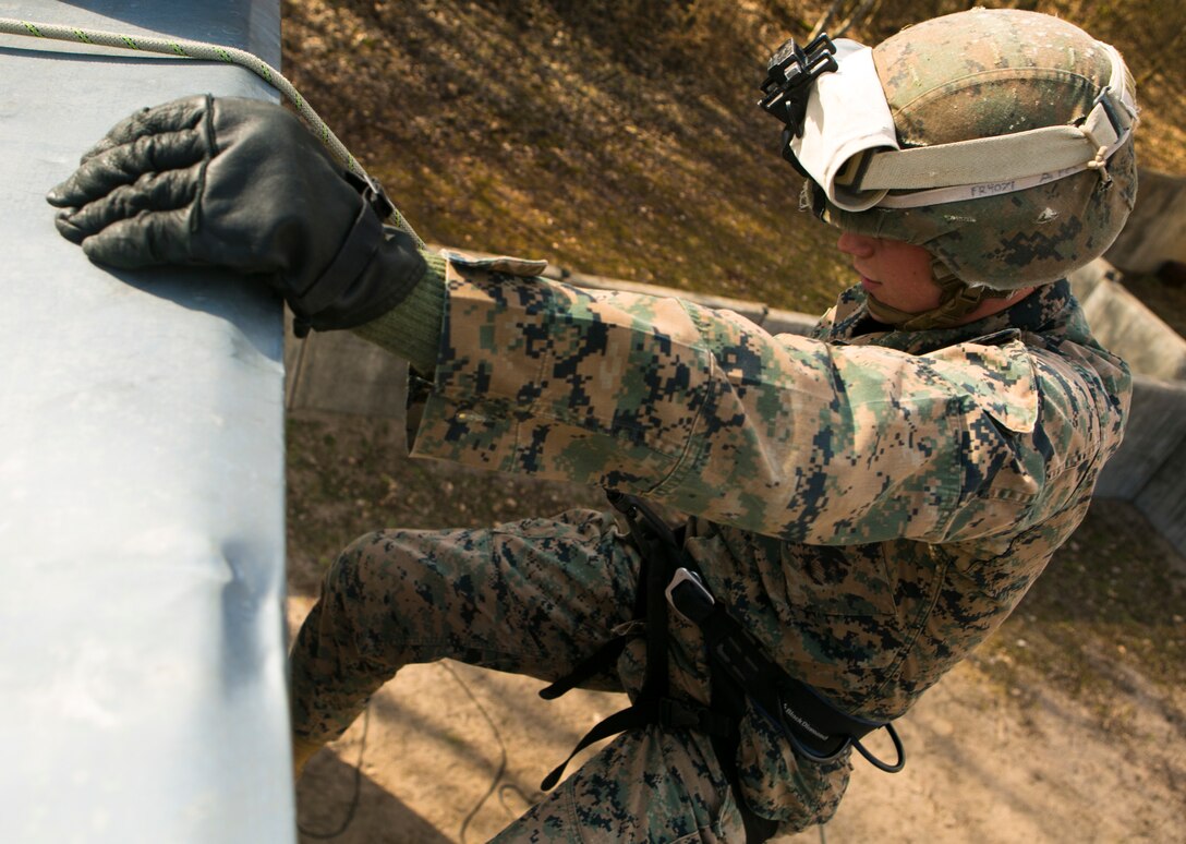 U.S. Marine Corps Cpl. Ethan Rhoades, with Special-Purpose Marine Air-Ground Task Force Crisis Response-Africa, rappels down a building during a training exercise with U.S. Army Special Forces in Baumholder, Germany, March 6, 2015. Special Forces personnel instructed the Marines on various rappelling techniques that will allow the two groups to increase their interoperability for potential future operations. (U.S. Marine Corps photo by Sgt. Paul Peterson/Released)