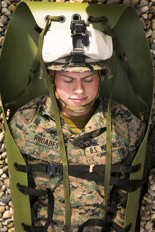 U.S. Marine Cpl. Ethan Rhoades, with Special-Purpose Marine Air-Ground Task Force Crisis Response-Africa, lies in a casualty sled during a training exercise with U.S. Army Special Forces in Baumholder, Germany, March 6, 2015. The Marines used the sled to lower Rhoades down a two-story structure, simulating the extraction of an incapacitated casualty in an urban environment. (U.S. Marine Corps photo by Sgt. Paul Peterson/Released)