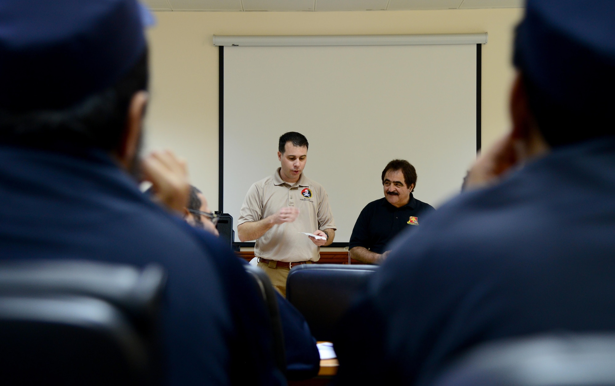 U.S. Special Agent Chad Hutchins, center, Forensics Science Consultant from the Federal Law Enforcement Training Center in Brunswick, Ga., discusses fingerprinting techniques with members of the Qatar Ministry of Interior’s Crime Scene Processing Unit during a liaison exchange, March 3, 2015, at the Criminal Evidence and Information Department, Ar-Rayyan, Qatar. During the liaison exchange, members from Air Force Office of Special Investigations Detachment 241 and their Qatari counterparts shared different forensic methods they use when investigating a crime scene. (U.S. Air Force photo by Senior Airman Kia Atkins)
