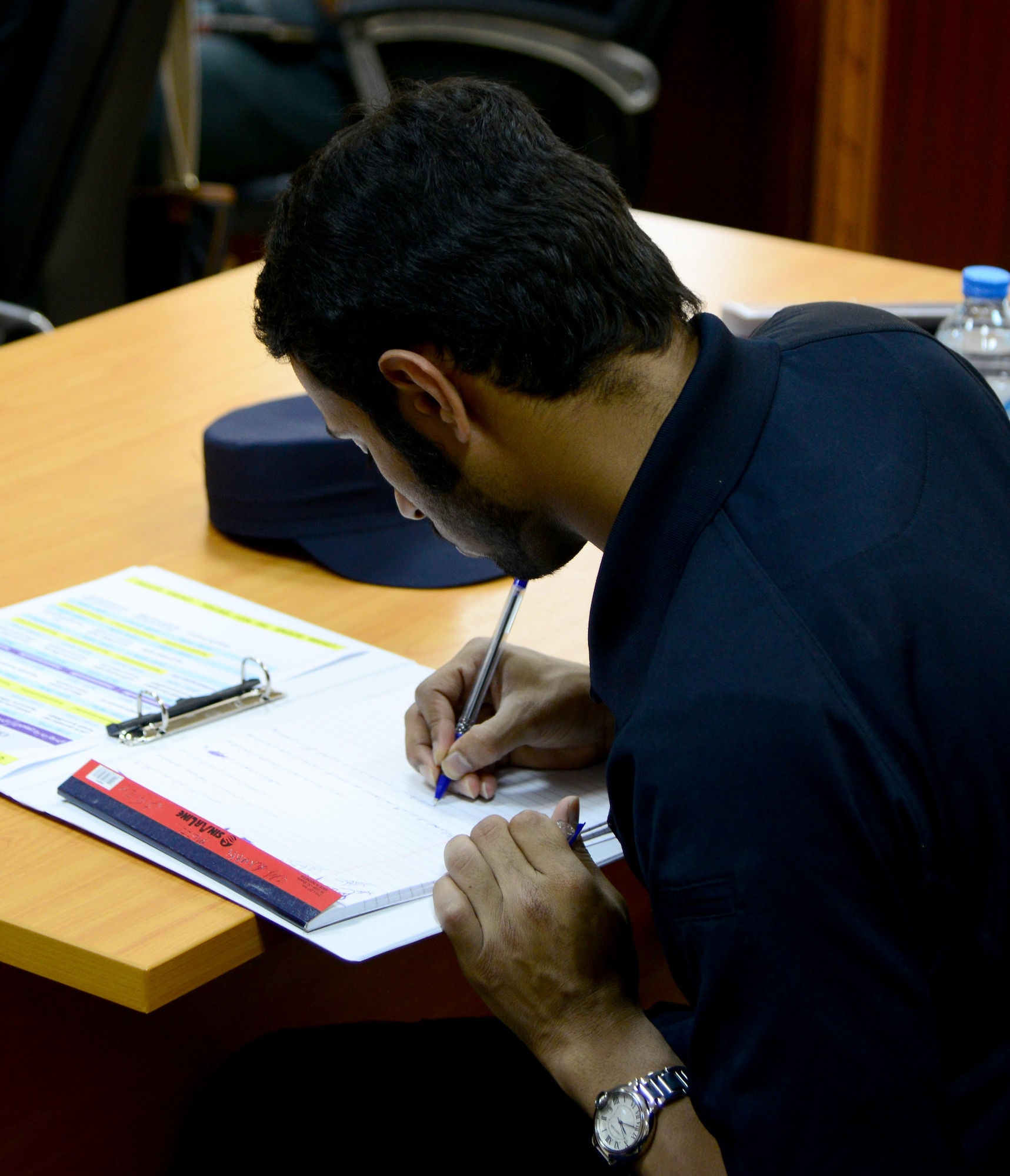 A member of the Qatar Ministry of Interior’s Crime Scene Processing Unit takes notes during a liaison exchange, March 3, 2015, at the Criminal Evidence and Information Department, Ar-Rayyan, Qatar. During the liaison exchange, members from Air Force Office of Special Investigations Detachment 241 and their Qatari counterparts shared different forensic methods they use when investigating a crime scene. (U.S. Air Force photo by Senior Airman Kia Atkins)