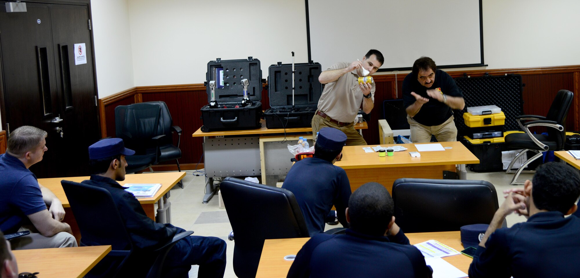 U.S. Special Agent Chad Hutchins, Forensics Science Consultant from the Federal Law Enforcement Training Center in Brunswick, Ga., demonstrates how he dusts for fingerprints on a can during a liaison exchange, March 3, 2015, at the Criminal Evidence and Information Department, Ar-Rayyan, Qatar. During the liaison exchange, members from Air Force Office of Special Investigations Detachment 241 and their Qatari counterparts shared different forensic methods they use when investigating a crime scene. (U.S. Air Force photo by Senior Airman Kia Atkins)
