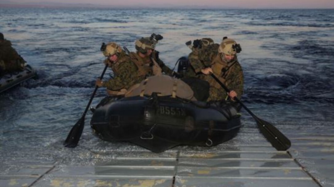 U.S. Marines with the 15th Marine Expeditionary Unit’s Maritime Raid Force disembark the USS Essex (LHD 2) during Amphibious Squadron/Marine Expeditionary Unit Integration Training (PMINT) off the coast of San Diego March 4, 2015. These Marines rode combat rubber raiding craft to a beach aboard Camp Pendleton, Calif., to execute a precision raid.