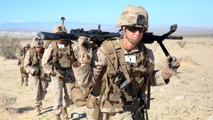 Sgt. Hannah S. Jacobson, machine gunner with Weapons Company, Ground Combat Element Integrated Task Force, and her machine-gun team maneuver to their support by fire position in preparation to engage targets during a Marine Corps Operational Test and Evaluation Activity assessment at Range 107, Marine Corps Air Ground Combat Center Twentynine Palms, March 10, 2015. From October 2014 to July 2015, the GCEITF will conduct individual and collective level skills training in designated ground combat arms occupational specialties in order to facilitate the standards-based assessment of the physical performance of Marines in a simulated operating environment performing specific ground combat arms tasks. 