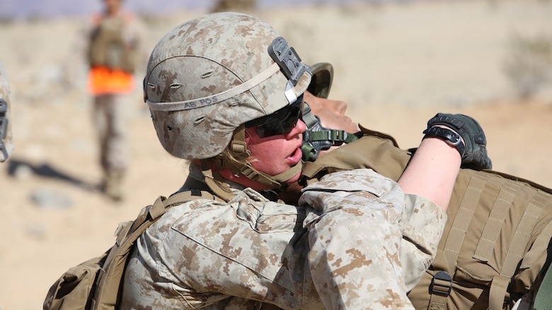 Cpl. Katie M. Gorz, team leader with 2nd Platoon, Company A, Ground Combat Element Integrated Task Force, conducts a fire-team assisted carry during a simulated casualty evacuation portion of a Marine Corps Operational Test and Evaluation Activity assessment at Range 107, Marine Corps Air Ground Combat Center Twentynine Palms, March 9, 2015. From October 2014 to July 2015, the GCEITF will conduct individual and collective level skills training in designated ground combat arms occupational specialties in order to facilitate the standards-based assessment of the physical performance of Marines in a simulated operating environment performing specific ground combat arms tasks.