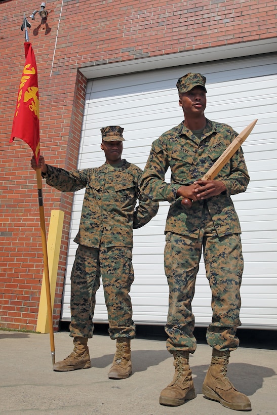 Cpl. Duane Levy, right, accepts the Leonidas Award as the junior Marine winner at Marine Corps Air Station Cherry Point, N.C., March 5, 2015.  During the squadron’s biannual Leonidas Award competition Marines from the squadron’s three companies go head-to-head for a place in Marine Wing Communication Squadron 28 history. The Leonidas Award serves to build camaraderie and esprit de corps within the noncommissioned officer and junior ranks of the squadron. Levy is a generator mechanic with Headquarters and Service Company for MWCS-28 and a native of Washington, D.C.