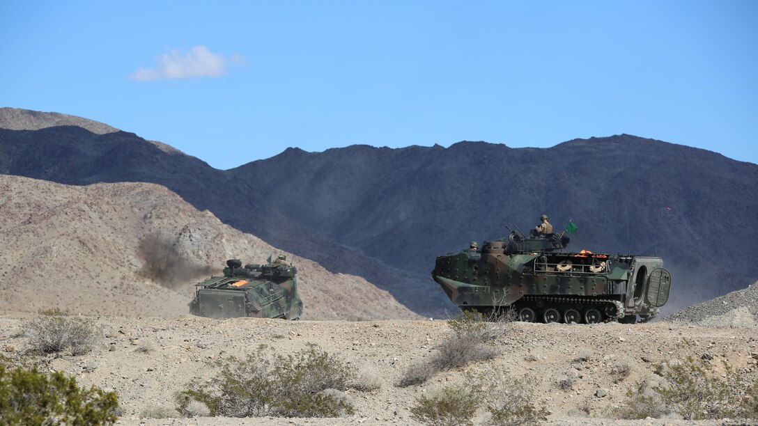 Marines with Amphibious Assault Vehicle Platoon, Company B, Ground Combat Element Integrated Task Force, roll out to firing positions during the assessment at Range 500, Marine Corps Air Ground Combat Center Twentynine Palms, California, March 3, 2015. From October 2014 to July 2015, the GCEITF will conduct individual and collective level skills training in designated ground combat arms occupational specialties in order to facilitate the standards-based assessment of the physical performance of Marines in a simulated operating environment performing specific ground combat arms tasks. 