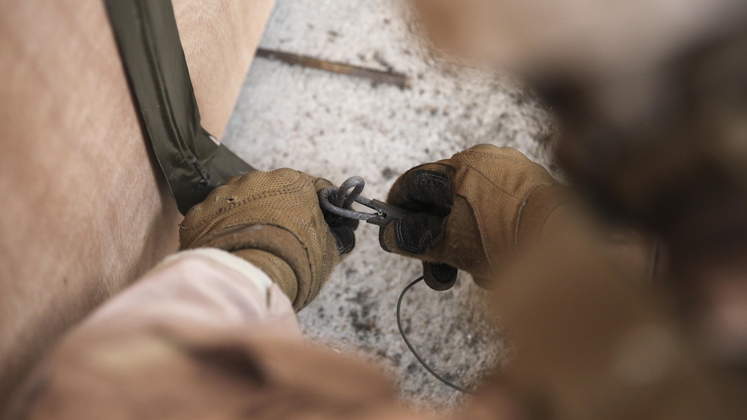 A Marine with 2nd Explosive Ordnance Disposal Company, 8th Engineer Support Battalion sets up an explosive charge to detonate during a dynamic entry sustainment course at a Military Operations in Urban Terrain exercise aboard Camp Lejeune, N.C., March 9, 2015.  Safety was a key aspect when conducting dynamic entry with explosive charges and Marines rehearsed each set up before going live. 