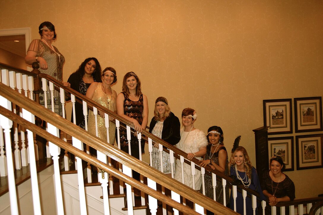Nicole Onuska, first vice president, Officers’ Spouses’ Club, (third from the right) poses in her twenties attire at the Officers’ Spouses’ Club auction,Double Gate Country Club, Albany, Ga., recently.