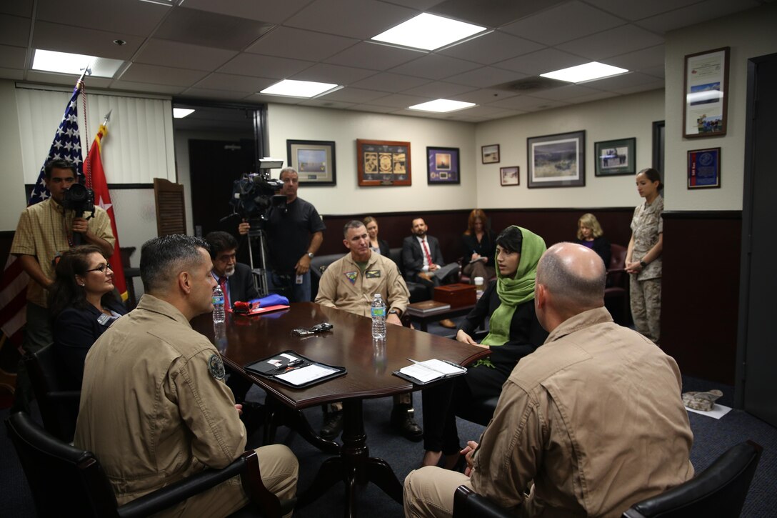 Captain Niloofar Rahmani, the first female fixed-wing pilot in the Afghan Air Force, speaks with Maj. Gen. Michael Rocco, 3rd Marine Aircraft Wing commanding general, and Col. John Farnam, commanding officer of Marine Corps Air Station Miramar, Calif. aboard the air station, March 9. Rahmani received the 2015 International Women of Courage award by the Department of state for her courage in advocating women’s rights despite personal risk.