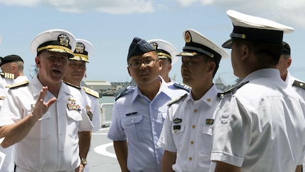 In this file photo, Capt. Joshua Hu (center) assists officials during their visit to the People’s Liberated Army navy hospital ship, the ARK PEACE, by the U.S. Pacific Command surgeon general and staff during Rim of the Pacific 2014. This was the first time Chinese ships participated in RIMPAC, the largest maritime exercise in the world. 