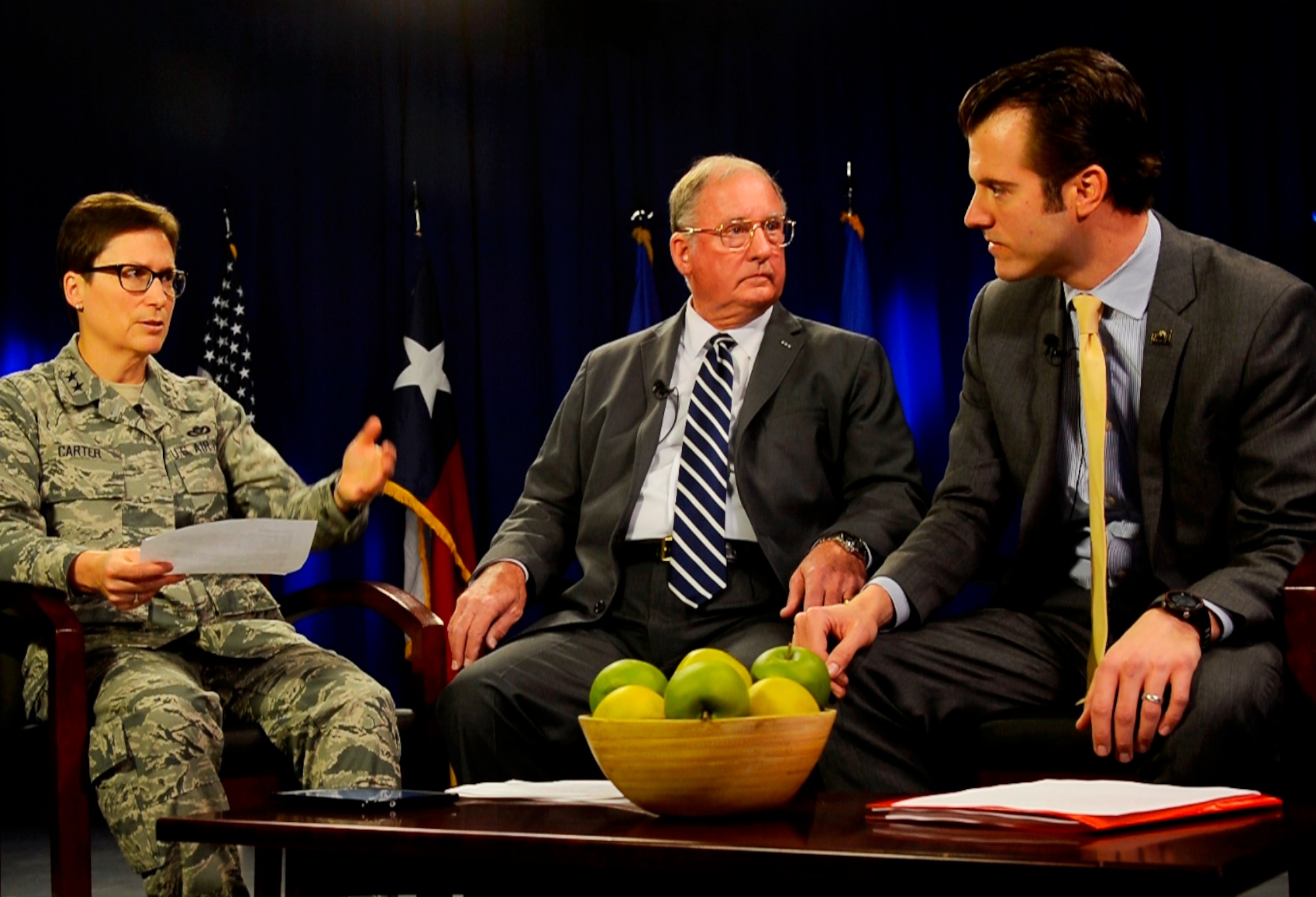 Maj. Gen. Theresa Carter, commander of the Air Force Installation and Mission Support Center (Provisional), discusses virtual town hall program content before going on the air with Bob Murdock (center), director of San Antonio Military Affairs, and Will Garrett, vice president of Economic Development for the San Antonio Chamber of Commerce. 