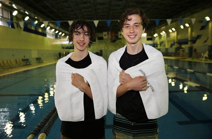 Spencer Boucher (left) and Aidan Lewis (right), 10th graders of Matthew C. Perry High School, pose after winning the cardboard boat science competition held at the IronWorks pool aboard Marine Corps Air Station Iwakuni, Japan, March 12, 2015. Boucher and Lewis were the only students to successfully venture down and back in the Olympic sized pool while one rowed with a handmade, cardboard paddle. “It feels pretty awesome to be the best out of everyone and we enjoyed competing,” said Boucher. “We learned a lot about the elements of math and science such as buoyancy and we worked as a team, that’s how we were successful.”