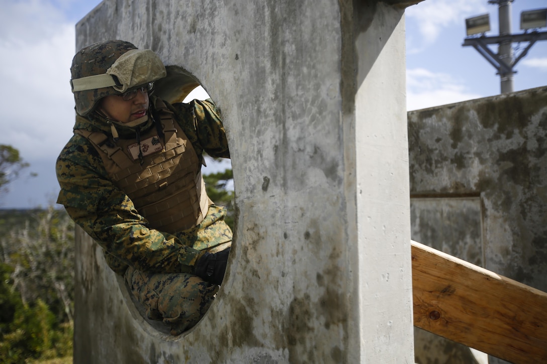 U.S. Marine Corps Sgt. David Lopez, with Combat Logistics Regiment 3, 3rd Marine Logistics Group, III Marine Expeditionary Force, helps his team to cross an obstacle on the confidence course during the unit’s Warrior Day at Camp Hansen, Okinawa, Japan, Feb. 9, 2015. The Warrior Day consisted of various team building exercises and obstacles in order to practice small unit leadership and enhance unit morale. (U.S. Marine Corps photo by MCIPAC combat camera Lance Cpl. Colby Cooper/Released)
