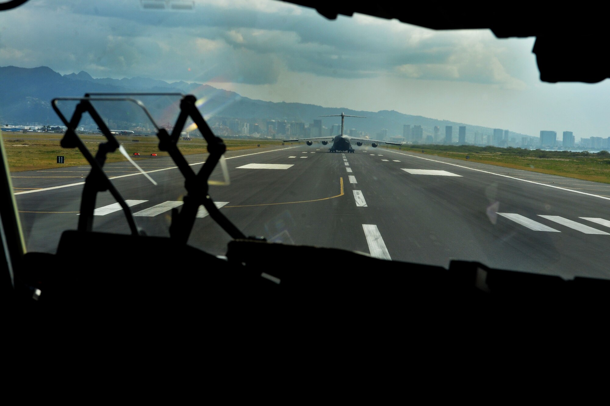 C-17 Globelmaste III, from the 535th Airlift Squadron, awaits takeoff on Joint Base Pearl Harbor-Hickam, Hawaii, Feb. 27, 2015. The aircraft will drop four combat delivery systems in support of the 25th Infantry Division’s Exercise Lightning Forge. (U.S. Air Force photo by Tech. Sgt. Aaron Oelrich/Released)