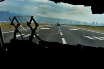 C-17 Globelmaste III, from the 535th Airlift Squadron, awaits takeoff on Joint Base Pearl Harbor-Hickam, Hawaii, Feb. 27, 2015. The aircraft will drop four combat delivery systems in support of the 25th Infantry Division’s Exercise Lightning Forge. (U.S. Air Force photo by Tech. Sgt. Aaron Oelrich/Released)