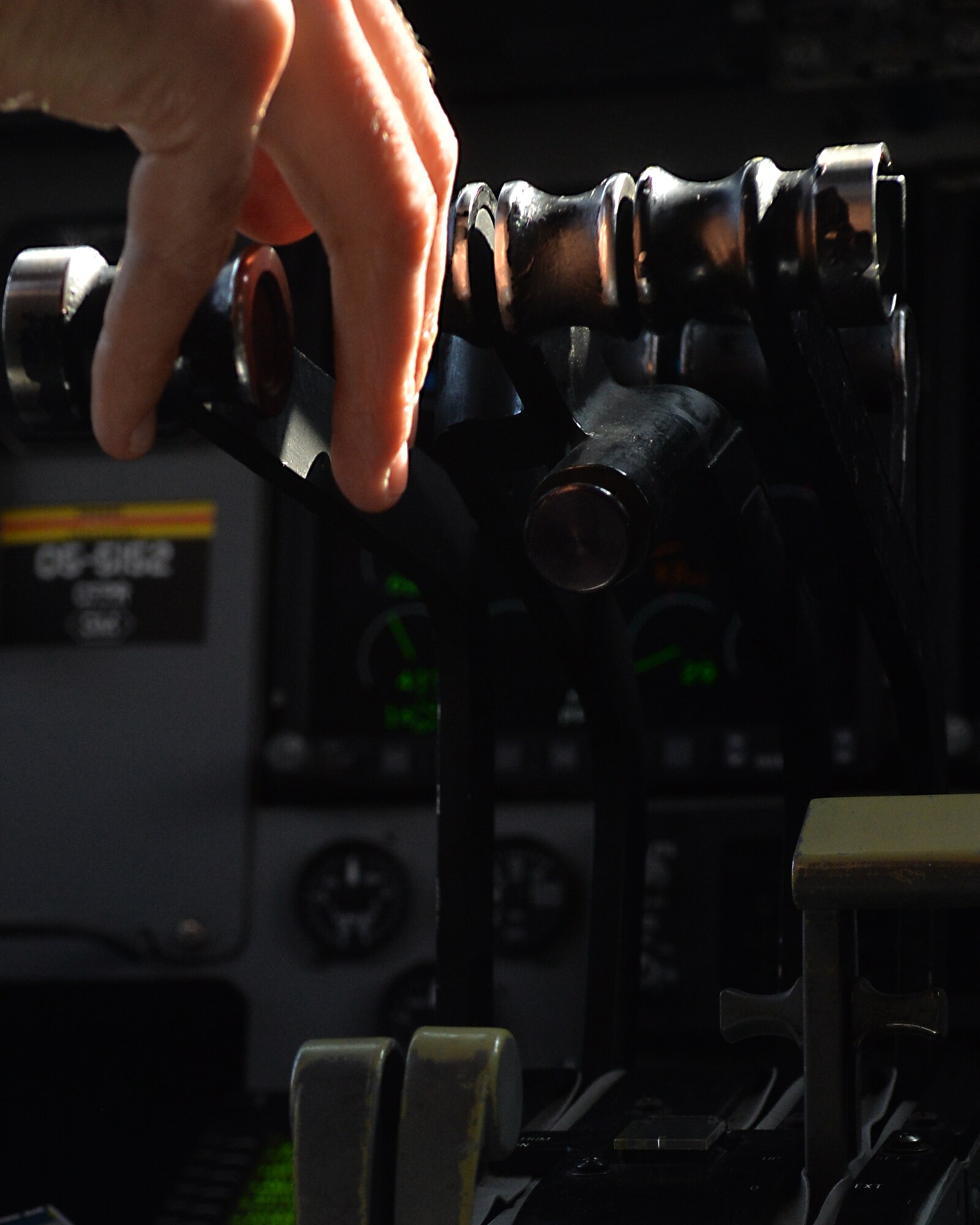 Maj Andrew Beckett, 535th Airlift Squadron pilot and aircraft commander, pushes back on the throttles of a C-17 Globemaster II in preparation for landing near Joint Base Pearl Harbor-Hickam, Hawaii, Feb. 27, 2015. Beckett is preparing to land after successfully airdropping four combat delivery systems to the 25th Infantry Division in support of Army Exercise Lightning Forge. (U.S. Air Force photo by Tech. Sgt. Aaron Oelrich/Released)