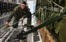 Senior Airmen Caleb Williams, a loadmaster from the 535th Airlift Squadron, secures four combat delivery systems in a C-17 Globelmaster III, in preparation for flight on Joint Base Pearl Harbor-Hickam, Hawaii, Feb. 27, 2015.The combat delivery systems will be airdropped to the 25th Infantry Division in support of Army Exercise Lightning Forge. (U.S. Air Force photo by Tech. Sgt. Aaron Oelrich/Released)