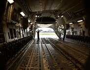 Senior Airmen Caleb Williams, a loadmaster from the 535th Airlift Squadron, checks the recovery cable on a C-17 Globelmaster III, Joint Base Pearl Harbor-Hickam, Hawaii, Feb. 27, 2015. The aircraft will drop four combat delivery systems in support of the 25th Infantry Division’s Exercise Lightning Forge. (U.S. Air Force photo by Tech. Sgt. Aaron Oelrich/Released)