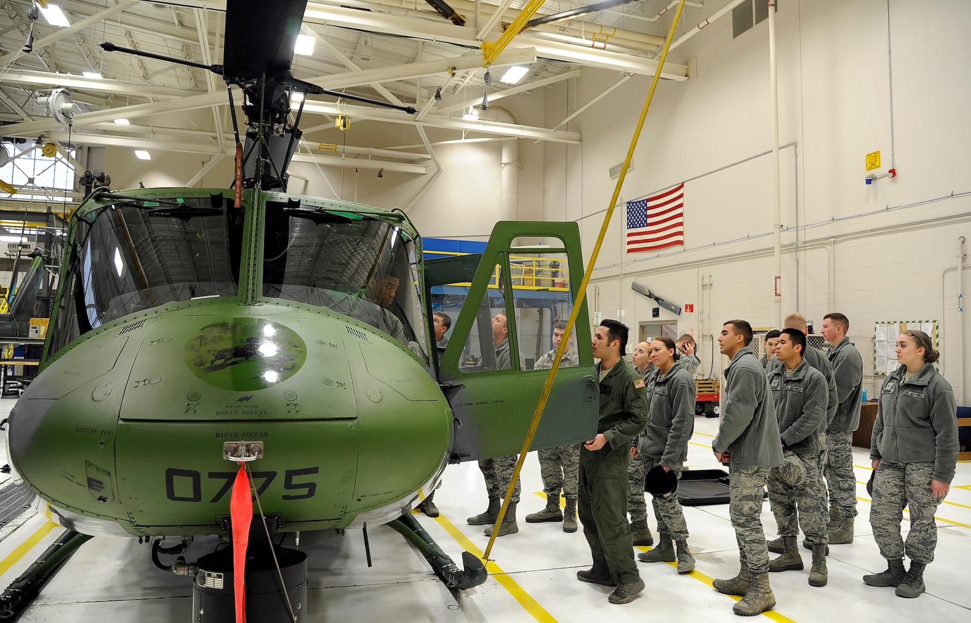 Staff Sgt. Eric McElroy, 40th Helicopter Squadron special mission aviator, provides a tour of a UH-1N helicopter to Airmen on a mission orientation tour at Malmstrom Air Force Base, Mont. The tour is part of inprocessing for first-term Airmen and incoming personnel. The 40th HS is one of many stops made on the tour. (U.S. Air Force photo/Staff Sgt. Delia Marchick)
