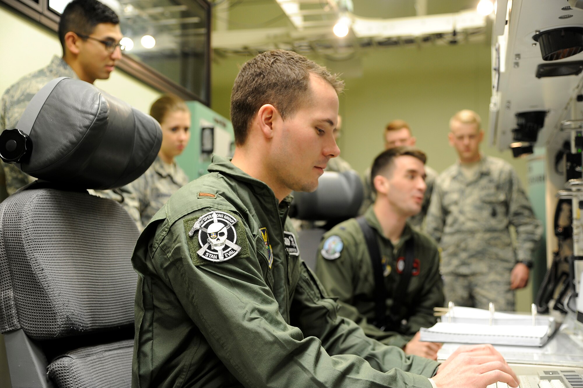 2nd Lt. Wesley Griffith, 341st Operations Group ICBM evaluator deputy combat crew commander and 1st Lt. Micheal Kraft, 12th Missile Squadron ICBM combat crew instructor, go through a simulated training checklist in the missile procedures trainer March 5. The MPT is the first stop on the monthly mission orientation tour held at Malmstrom Air Force Base, Mont. (U.S. Air Force photo/Staff Sgt. Delia Marchick)