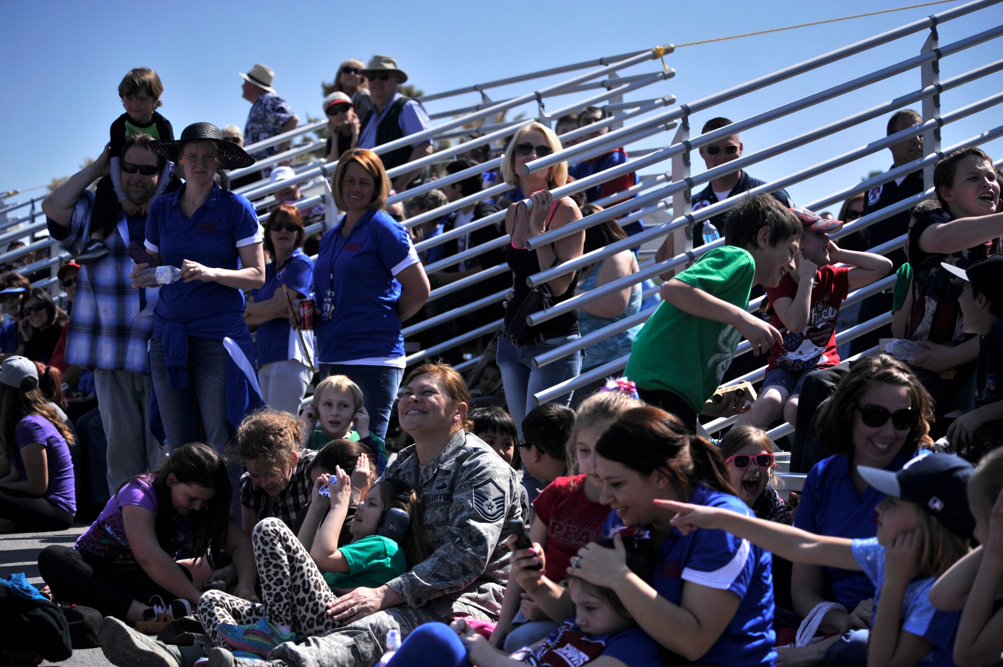 Indian Springs Appreciation Day spectators watch the U.S. Air Force Air Demonstration Squadron Thunderbirds performance March 10, 2015 at Creech Air Force Base, Nevada. The annual event gives Airmen the opportunity to showcase the base mission, aircraft, and build relationships with the Indian Springs populace. (U.S. Air Force photo by Airman 1st Class Christian Clausen/Released)