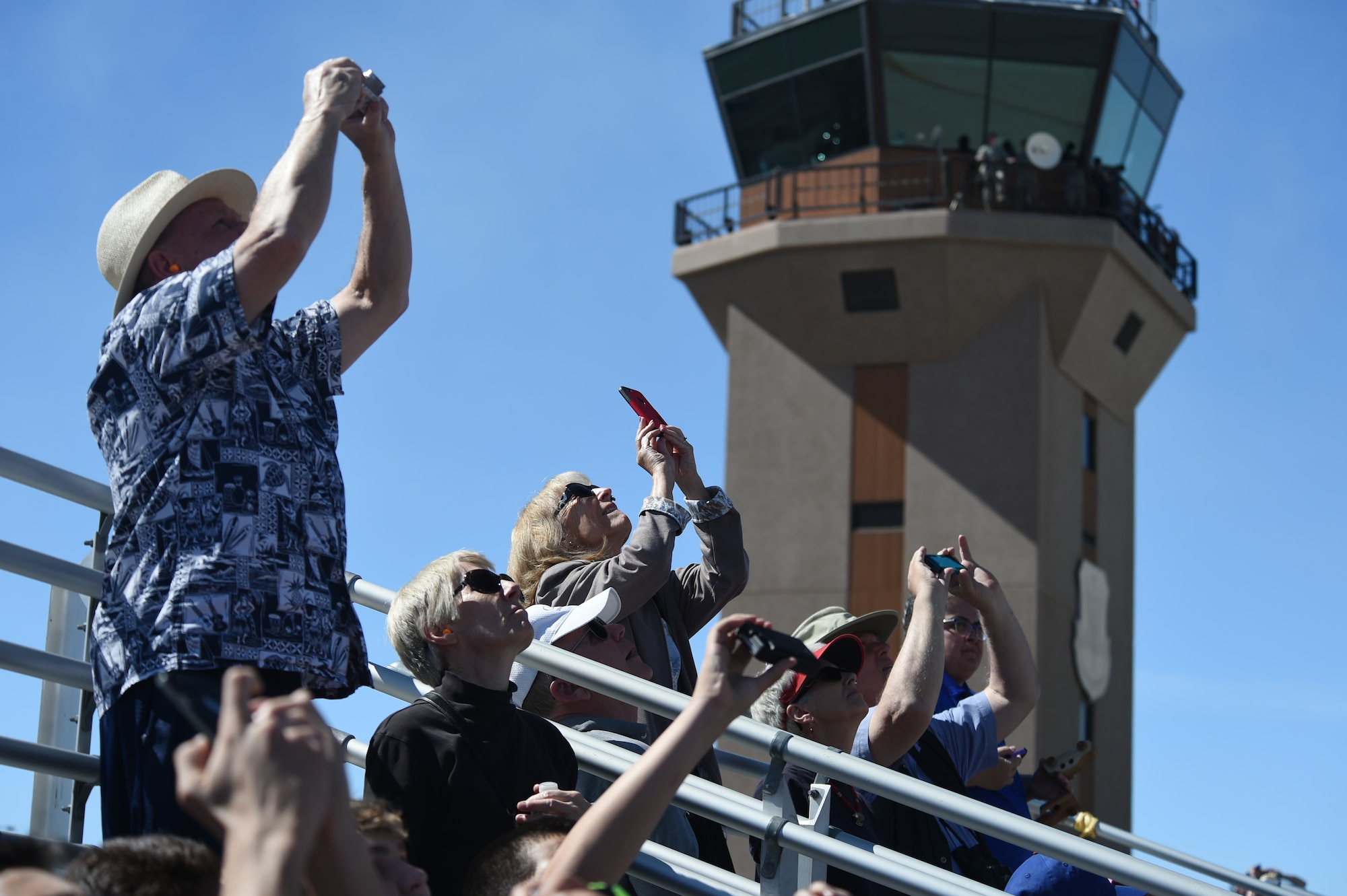Residents from the local community enjoy the U.S. Air Force Air Demonstration Squadron Thunderbirds demonstration during Indian Springs Appreciation Day March 10, 2015, at Creech Air Force Base, Nevada. During the event, Indian Springs populace watched Airmen demonstrate MQ-9 Reaper loading techniques on the MQ-9 Reaper, enjoyed food and drinks, as well as visited booths set up by various Air Force members and associations. (U.S. Air Force photo by Tech. Sgt. Shad Eidson/released)