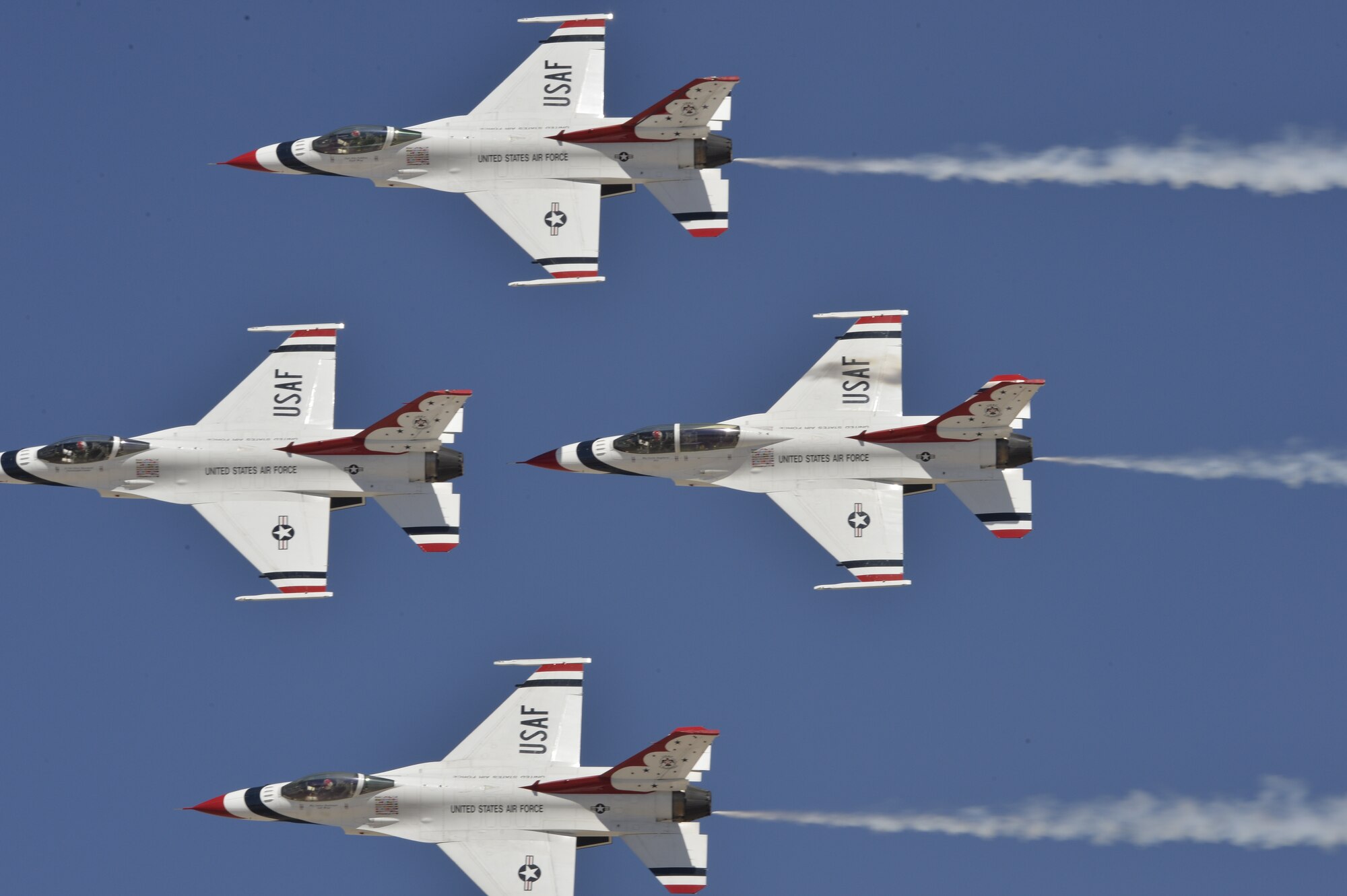 The U.S. Air Force Air Demonstration Squadron Thunderbirds perform their arrowhead loop routine during Indian Springs Appreciation Day March 10, 2015 at Creech Air Force Base, Nevada. The demonstration is a mix of six aircraft performing formation flying and solo routines. The four-ship Diamond formation demonstrates the precision and training of Air Force pilots, as well as the gracefulness of the F-16. The two solos display the power and maximum capabilities of the mighty F-16 Fighting Falcon, a front-line fighter. (U.S. Air Force photo by Tech Sgt. Nadine Barclay/Released)
