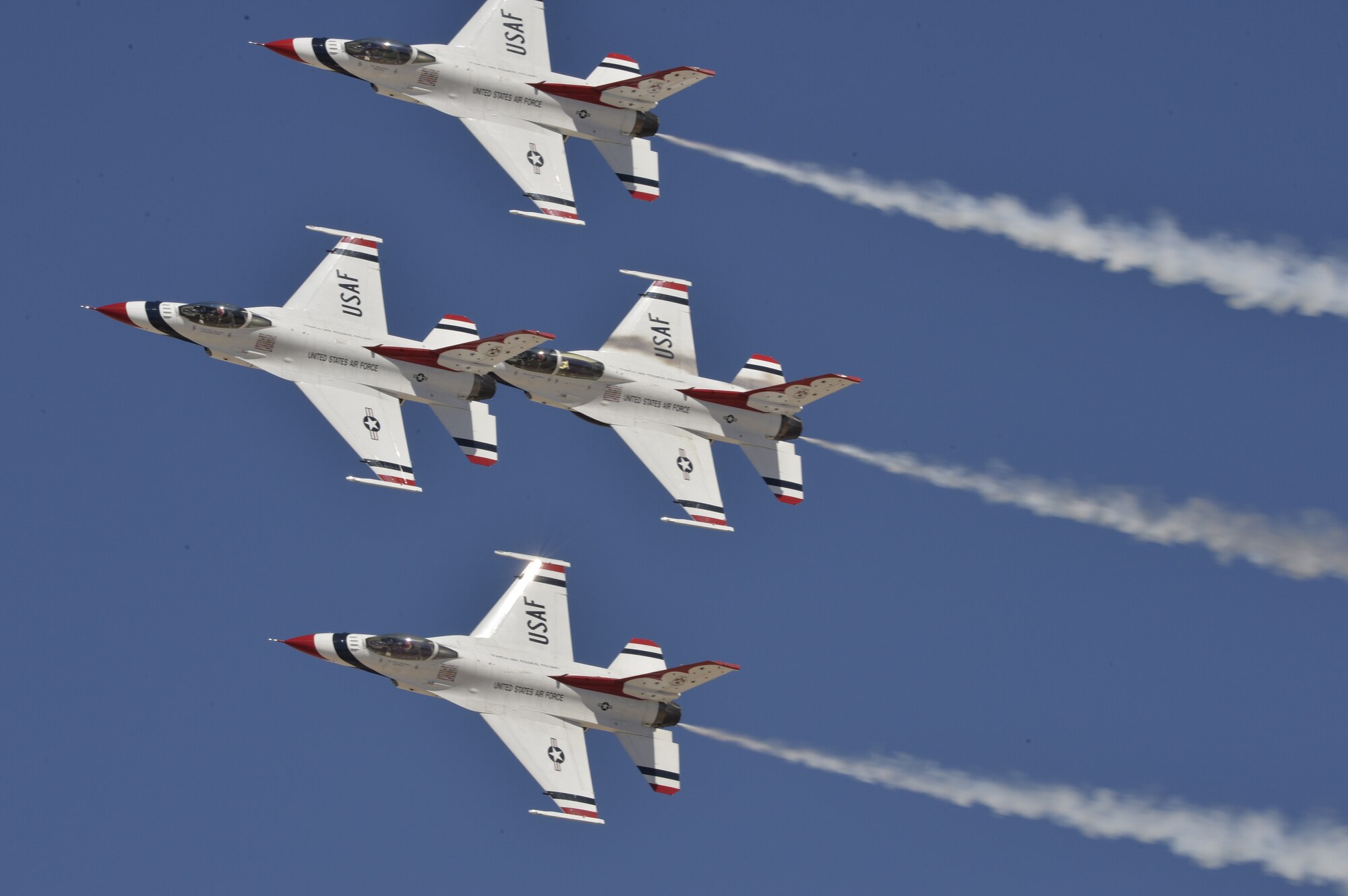 The U.S. Air Force Air Demonstration Squadron Thunderbirds perform their arrowhead loop routine during Indian Springs Appreciation Day March 10, 2015 at Creech Air Force Base, Nevada. The demonstration is a mix of six aircraft performing formation flying and solo routines. The F-16 Fighting Falcon four-ship Diamond formation demonstrates the precision and training of Air Force pilots, as well as the gracefulness of the F-16. The two solos display the power and maximum capabilities of the mighty F-16, a front-line fighter. (U.S. Air Force photo by Tech Sgt. Nadine Barclay/Released)