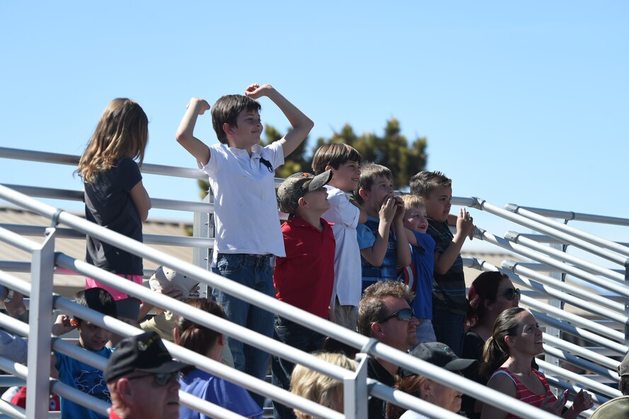 Children cheer for the U.S. Air Force Air Demonstration Squadron Thunderbirds as they perform the Calypso formation during Indian Springs Appreciation Day March 10, 2015, at Creech Air Force Base, Nevada. Students and members of the local community attended the annual event to learn about the base’s various Air Force missions. (U.S. Air Force photo by Tech. Sgt. Shad Eidson/released)