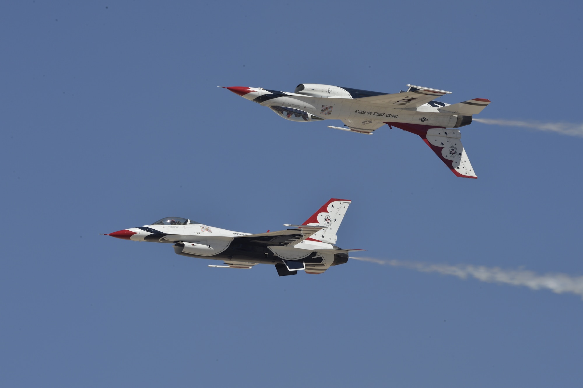 The U.S. Air Force Air Demonstration Squadron Thunderbirds perform their calypso routine during Indian Springs Appreciation Day March 10, 2015 at Creech Air Force Base, Nevada. The event is held annually to strengthen relation between the local populace and the Airmen assigned to Creech. The demonstration is a mix of six aircraft performing formation flying and solo routines. The F-16 Fighting Falcon four-ship Diamond formation demonstrates the precision and training of Air Force pilots, as well as the gracefulness of the F-16. The two solos display the power and maximum capabilities of the mighty F-16, a front-line fighter.   (U.S. Air Force photo by Tech Sgt. Nadine Barclay/Released)