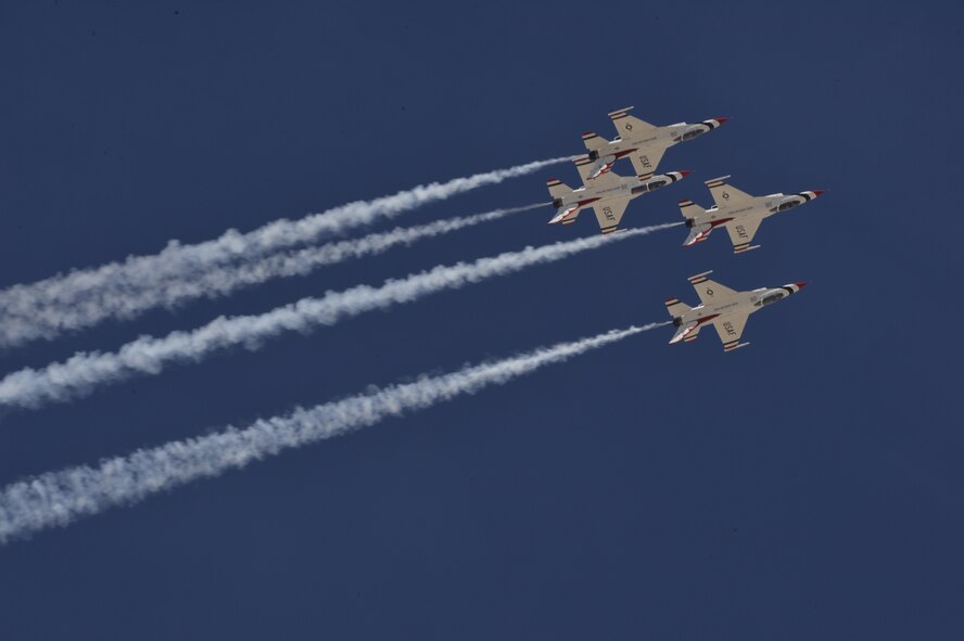 The U.S. Air Force Air Demonstration Squadron Thunderbirds perform their arrowhead loop routine during Indian Springs Appreciation Day March 10, 2015 at Creech Air Force Base, Nevada. The demonstration is a mix of six aircraft performing formation flying and solo routines. The F-16 Fighting Falcon four-ship Diamond formation demonstrates the precision and training of Air Force pilots, as well as the gracefulness of the F-16. The two solos display the power and maximum capabilities of the mighty F-16, a front-line fighter. (U.S. Air Force photo by Tech Sgt. Nadine Barclay/Released)