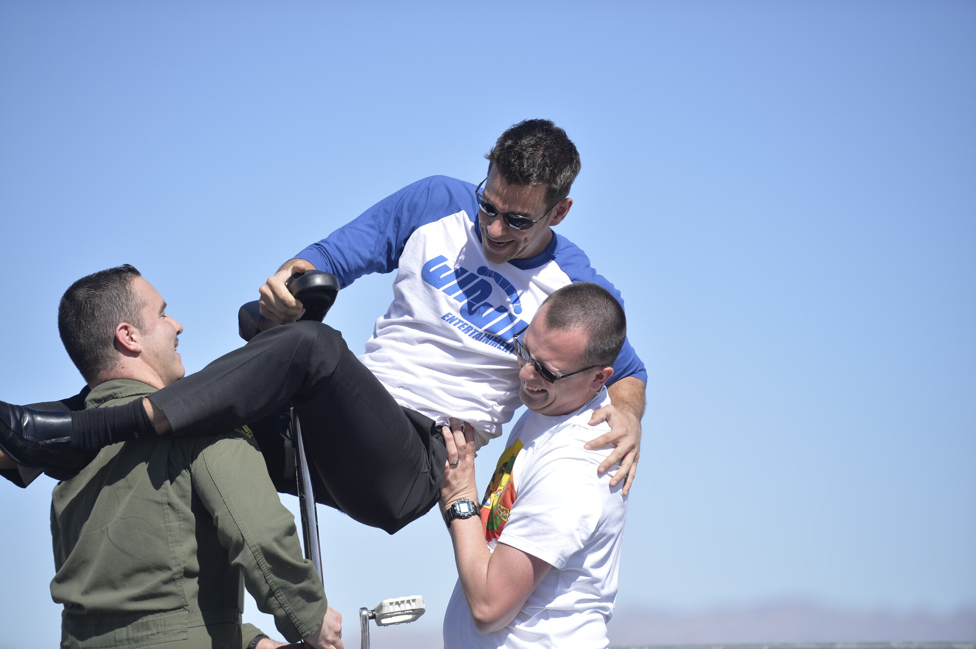 Indian Springs Appreciation Day spectators help Las Vegas entertainer Jeff Civillico onto a unicycle during his performance March 10, 2015 at Creech Air Force Base, Nevada. Civillico performed an interactive comedy act for the Indian Springs community and base members and their families. (U.S. Air Force photo by Tech Sgt. Nadine Barclay/Released)