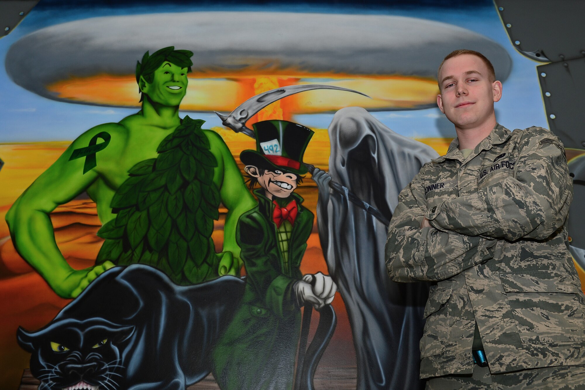 Staff Sgt. Alexander Conner, 48th Aircraft Maintenance Squadron dedicated crew chief, poses in front of a 492nd Aircraft Maintenance Unit mural at Royal Air Force Lakenheath, England, March 12, 2015. Conner was nominated for a Liberty Spotlight because he embodies the core value of Excellence In All We Do. (U.S. Air Force photo by Airman 1st Class Erin R. Babis/Released)