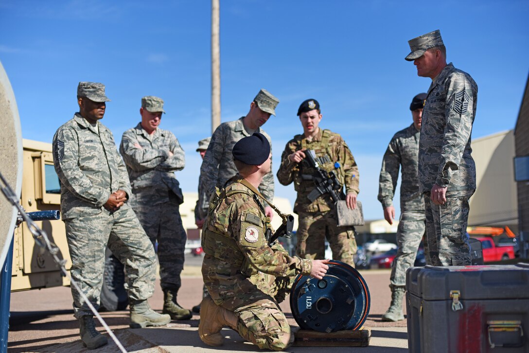Security forces personnel from the 341st Security Forces Group explain key components of a launch facility at Malmstrom Air Force Base, Mont., to Chief Master Sgt. of the Air Force James Cody (right) during a tour of the base March 8-10. As part of his visit, Cody toured missile alert facilities and learned how Airmen operate on a day-to-day basis. (U.S. Air Force photo/Airman 1st Class Collin Schmidt)