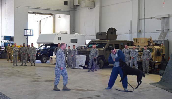 Members of the 341st Security Forces Group put on a military working dog demonstration for Chief Master Sgt. of the Air Force James Cody during a tour of Malmstrom Air Force Base, Mont., March 8-10. Before the demonstration, Cody learned of the vehicles, equipment and weapons Malmstrom’s defenders use while deployed to the missile field. (U.S. Air Force photo/Airman 1st Class Collin Schmidt)