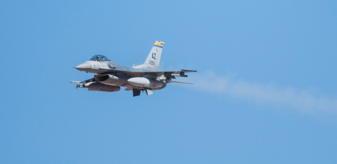 An F-16 Fighting Falcon from the 162nd Wing drops munitions on a target at Barry M. Goldwater Air Force Range during a Turkey Shoot competition held March Unit Training Assembly. (U.S. Air National Guard Photo by Staff Sgt. Gregory Ferreira/Released) 