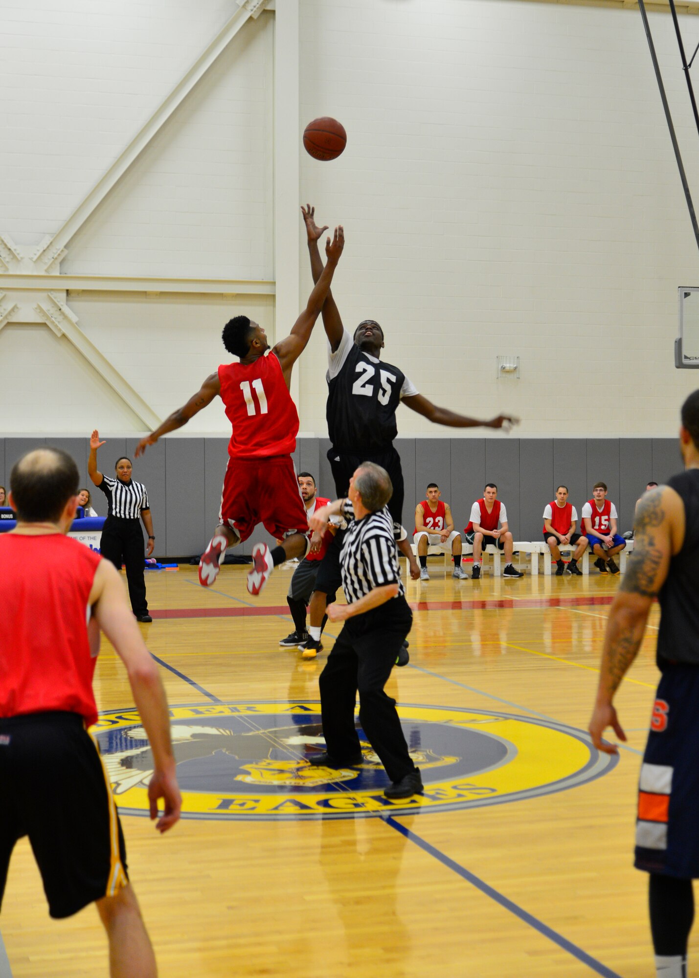 Derrick Davis, left, 436th Force Support Squadron small forward, and Domonic Townsend, right,  512th Airlift Wing small forward, jump up for the tip-off at the start of overtime game play March 10, 2015, during an intramural basketball game at the fitness center on Dover Air Force Base, Del. The 436th FSS defeated the 512th AW 49-44 and clinched the American League’s number one seed going into the playoffs. (U.S. Air Force photo/Airman 1st Class William Johnson)