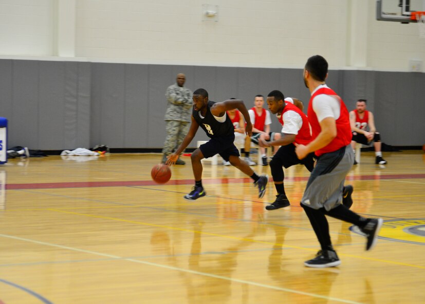Lateef Shinaba, 512th Airlift Wing point guard, charges down the court March 10, 2015, during an intramural basketball game at the fitness center on Dover Air Force Base, Del. Lateef scored a staggering 22 out of the 44 points by the 512th AW, but still came up short against the 49 points put up by the 436th Force Support Squadron. (U.S. Air Force photo/Airman 1st Class William Johnson)