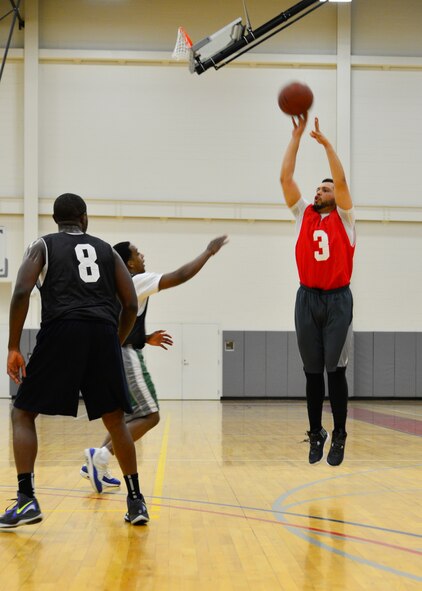 Angel Ramos, 436th Force Support Squadron, forward, drains a 3-pointer March 10, 2015, during an intramural basketball game at the fitness center on Dover Air Force Base, Del. The 436th FSS defeated the 512th Airlift Wing 49-44, finishing the season with an overall record of 10-2 and advancing to the playoffs as the number one seed in the American League. (U.S. Air Force photo/Airman 1st Class William Johnson)