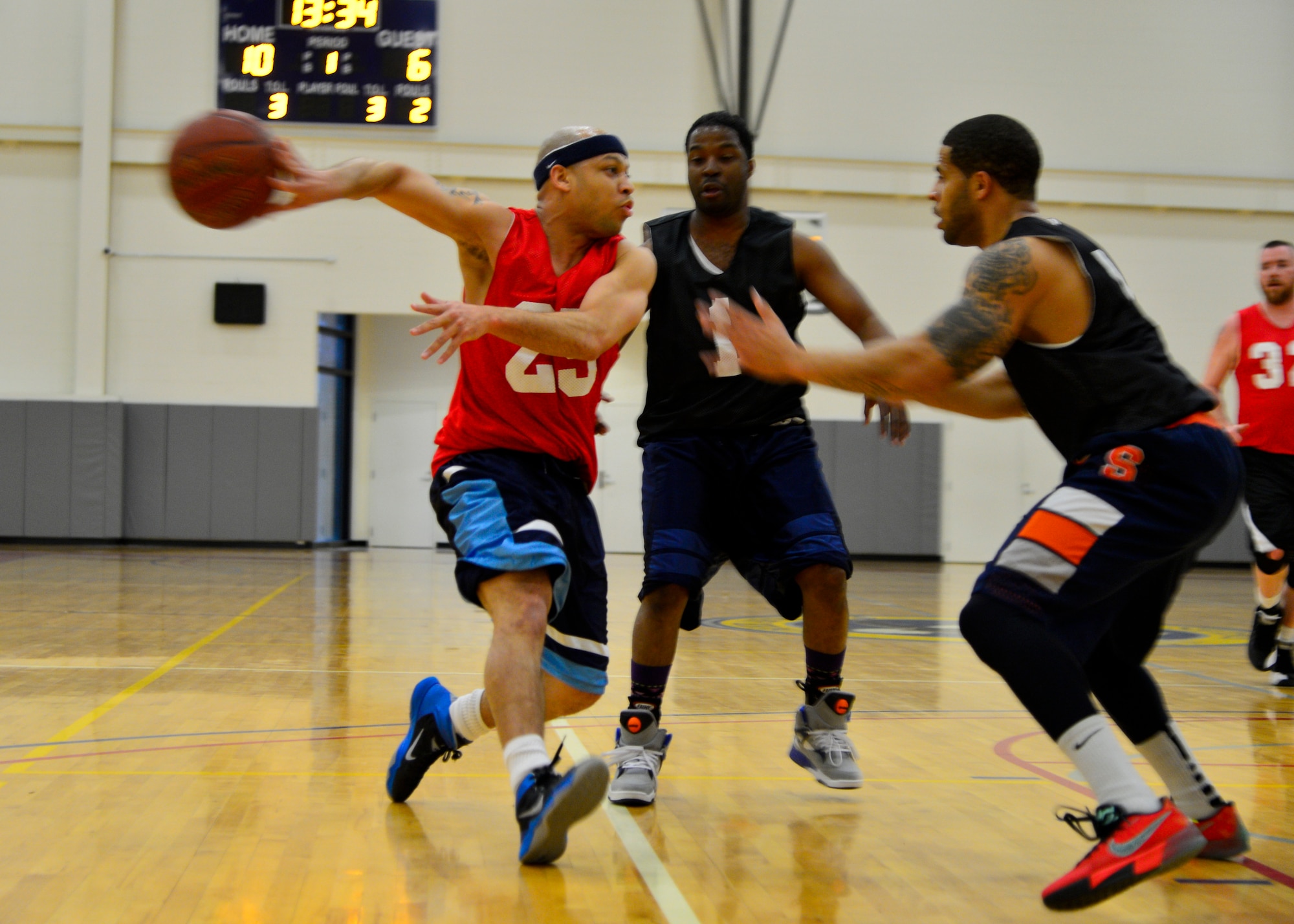 Antwan Piper, 436th Force Support Squadron player-coach, passes the ball behind him March 10, 2015, during an intramural basketball game at the fitness center on Dover Air Force Base, Del. The 436th FSS defeated the 512th Airlift Wing 49-44 in their last regular season game. (U.S. Air Force photo/Airman 1st Class William Johnson)