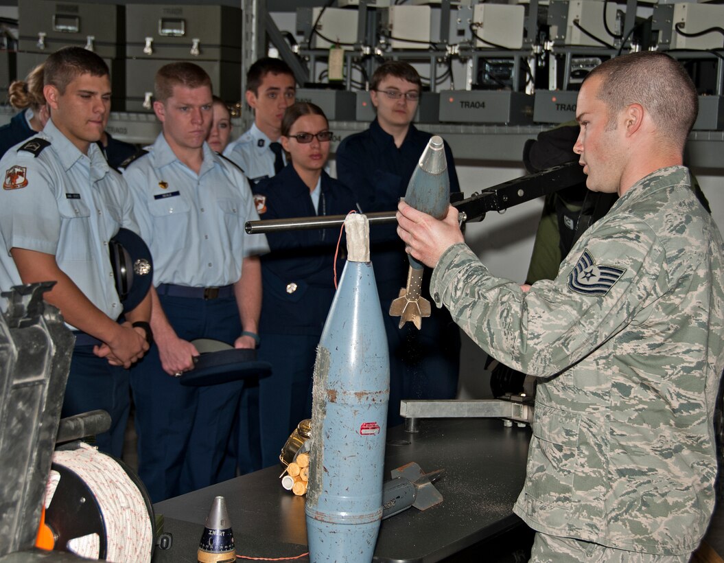 U.S. Air Force Tech. Sgt. Kyle Nason, 366th Training Squadron explosive ordinance disposal instructor, demonstrates the operation and disposal of an explosive device to the Burkburnett High School Air Force Junior ROTC cadets on Sheppard Air Force Base, Texas, March 11, 2015. The AFJROTC cadets are part of a base tour hosted by the Sheppard Air Force Base Public Affairs Department. (U.S. Air Force photo by Frank Carter/Released)