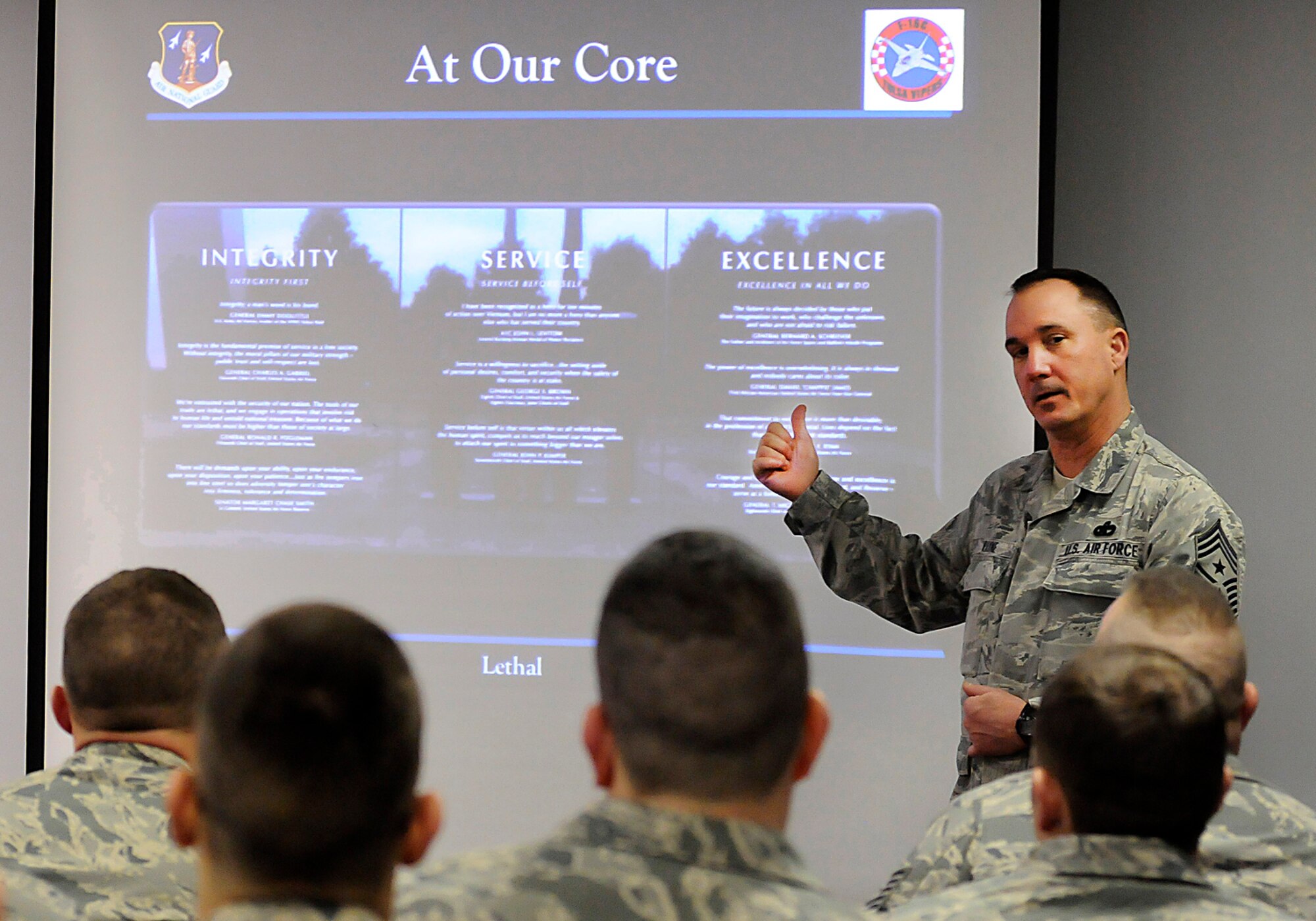 Chief Master Sgt. Thomas H. Payne, 138th Fighter Wing command chief, addresses airmen from the 138thSecurity Forces Squadron during a wing commander's town hall meeting 7 March 2015, at the Tulsa Air National Guard base, Okla.   The command staff visited select units on the installation, and plan on rotating visitations throughout all the organizations during future UTA’s.  (U.S. National Guard photo by Tech. Sgt. Roberta A. Thompson/Released)