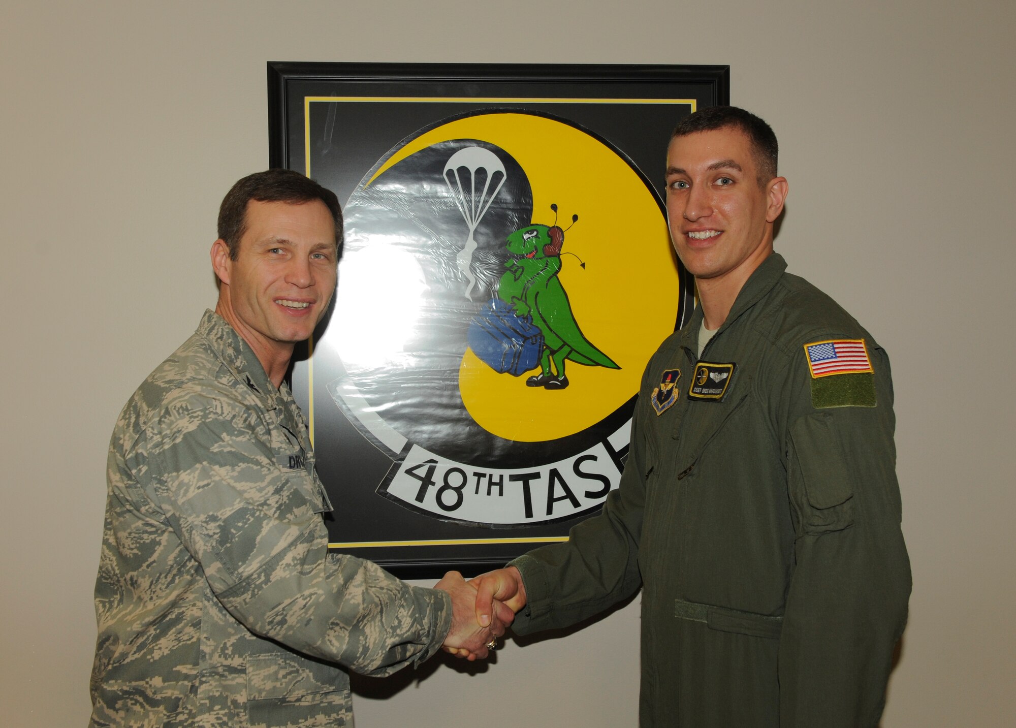 Col. James Dryjanski, the 314th Airlift Wing commander, congratulates Staff Sgt. Greg Marquardt, a 48th Airlift Squadron C-130J Formal Training Unit instructor loadmaster, on his selection as Combat Airlifter of the Week March, 10, 2015, at Little Rock Air Force Base, Ark. Marquardt earned the 314th Operational Group instructor loadmaster of the quarter and the Squadron Mission Support  non-commissioned officer of the quarter. (U.S. Air Force photo by Airman 1st Class Scott Poe) 