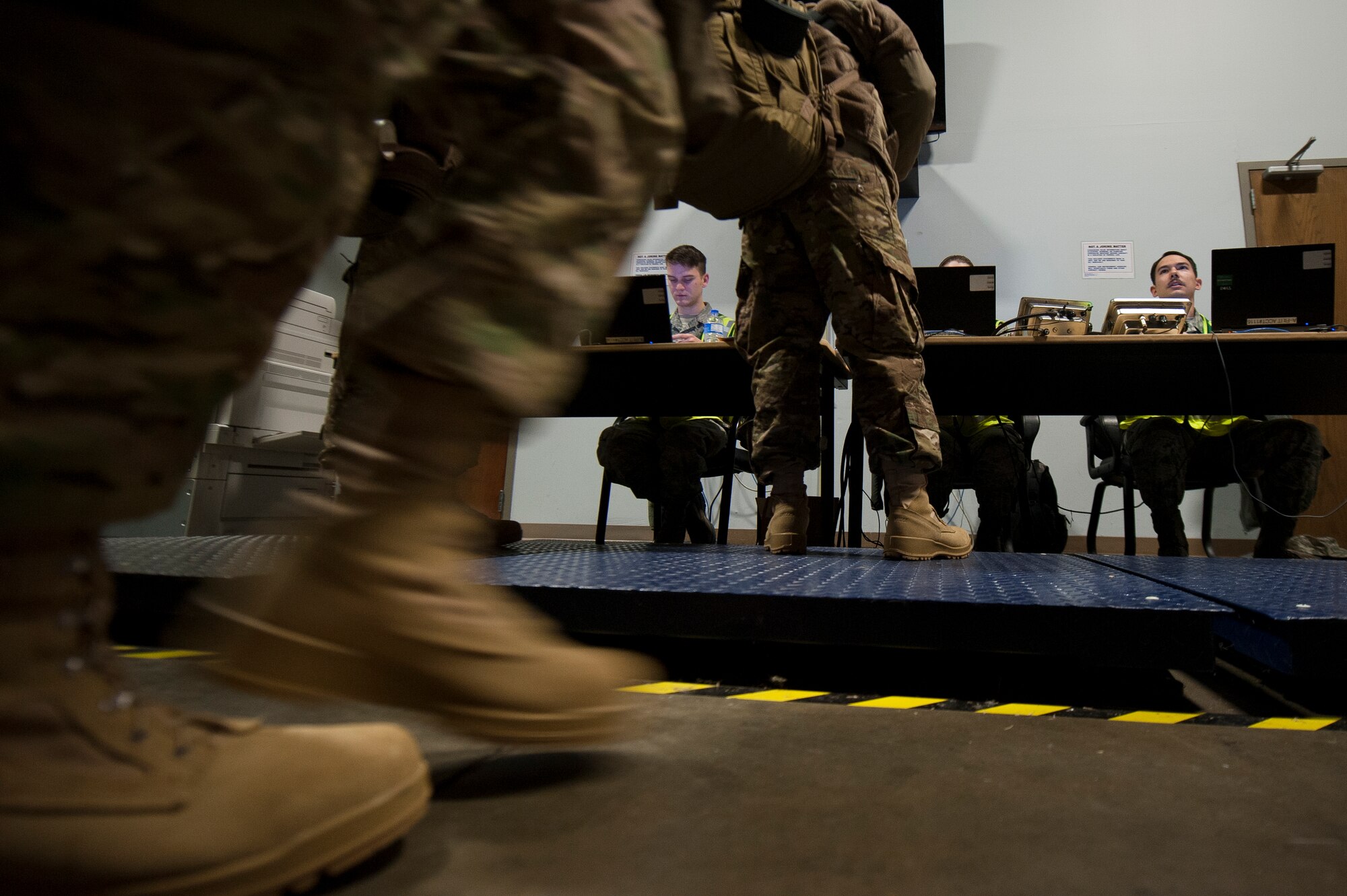 Deployers wait in line to get their weight recorded March 4, 2015, at Little Rock Air Force Base, Ark. The 19th Logistic Readiness Squadron checked mobility folders and weighed bags prior to Airmen boarding the plane. (U.S. Air Force photo by Senior Airman Kaylee Clark)