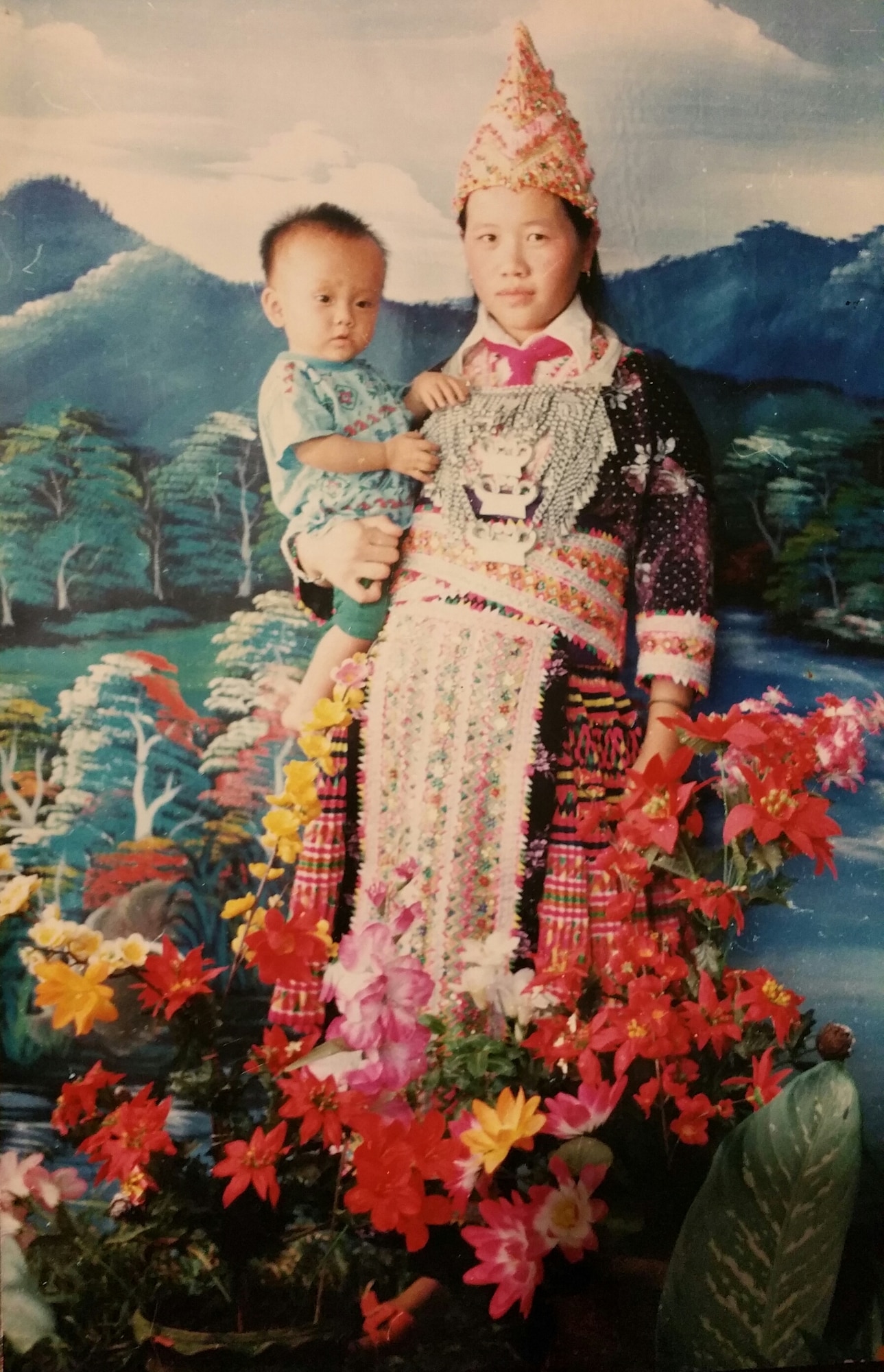 Senior Airman Yia Thao, age 1, poses for a portrait with his mother, Mai Song Her, in traditional Hmong ceremonial attire worn for significant events. (Courtesy photo)