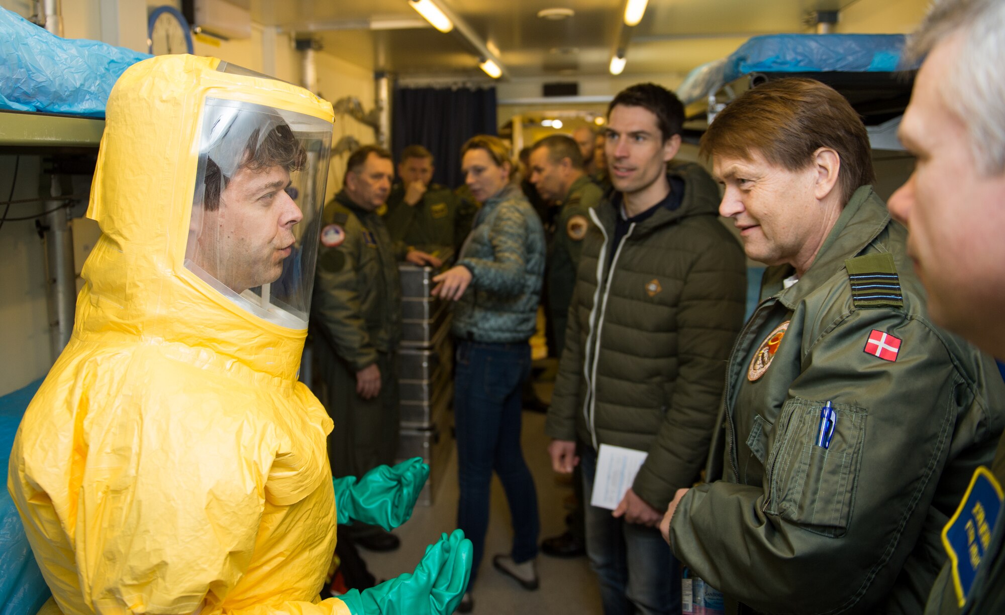 Two Royal Danish air force airmen discuss the aeromedical evacuation unit during a tour they gave to over 200 aerospace medicine professionals at Ramstein Air Base, Germany, March 11, 2015. The Danish and 18 other nations participated in the 30th Ramstein Aerospace Medicine Summit and NATO Science and Technology Organization Technical Course. (U.S. Air Force photo/Staff Sgt. Armando A. Schwier-Morales) 