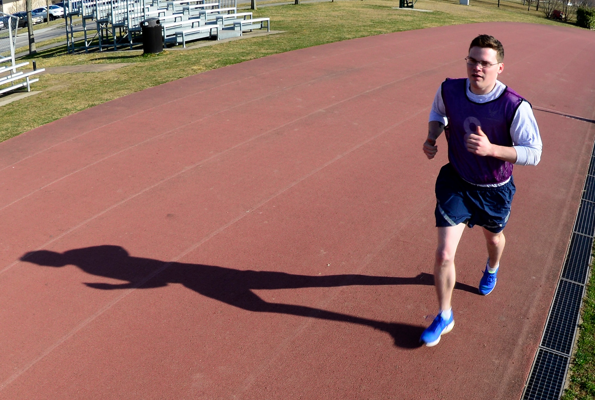 U.S. Air Force Airman 1st Class Josiah Hamernick, 31st Civil Engineer Squadron explosive ordinance apprentice, participates in the run portion of a physical fitness assessment test, March 11, 2015 at Aviano Air Base, Italy. Airmen are evaluated in four portions of the test – push-ups, sit-ups, abdominal circumference measurement and a 1.5-mile run. (U.S. Air Force photo by Senior Airman Areca T. Wilson/Released)