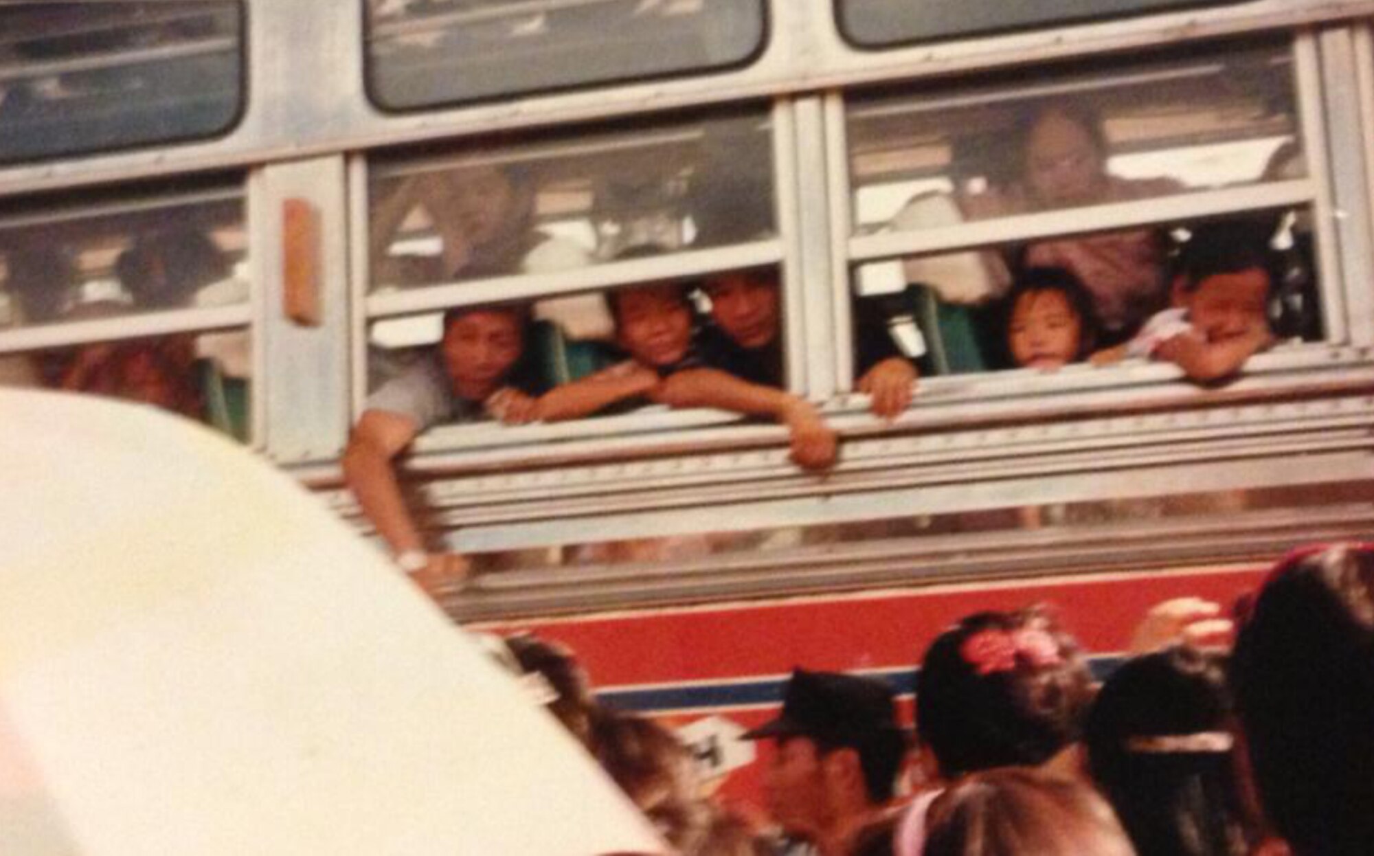 Senior Airman Yia Thao and his family wave goodbye to friends and other family members as they embark on their journey to the U.S. Sept. 1991. Many family members did not leave the refugee camp until it closed down in 2002. (Courtesy photo)