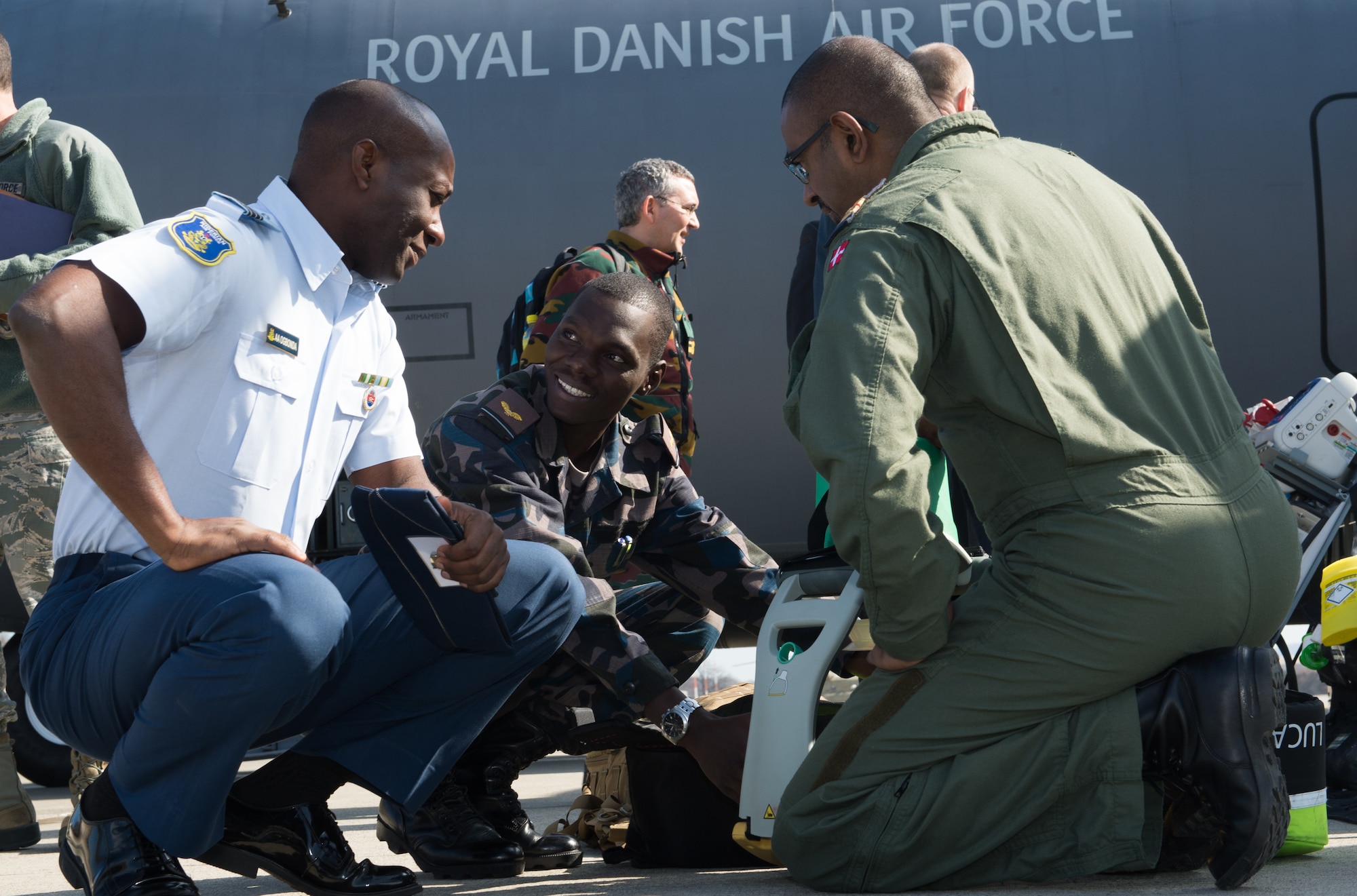 Two Nigerian air force and a Royal Danish air force airmen discuss medical evacuation equipment during a tour of a Danish C-130J Super Hercules at Ramstein Air Base, Germany, March 11, 2015. The Royal Danish Air Force showcased their aeromedical evacuation capabilities used for the transfer of Ebola patients during the 30th Ramstein Aerospace Medicine Summit and NATO Science and Technology Organization Technical Course. (U.S. Air Force photo/Staff Sgt. Armando A. Schwier-Morales) 